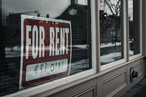 Image of a red for rent poster hanging in a window